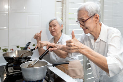 Senior couple preparing food at home