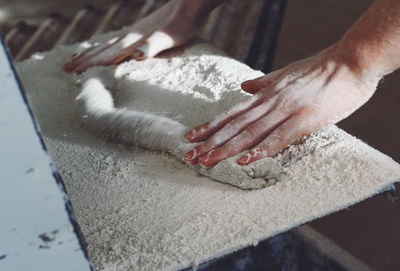 Close-up of hands making dough