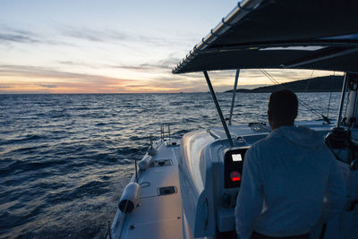 Rear view of man on boat sailing in sea