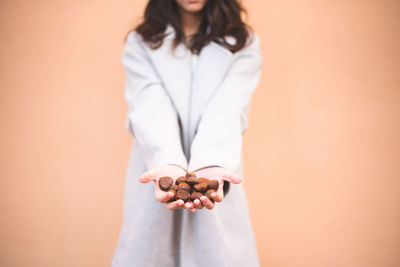 Midsection of woman standing against white background