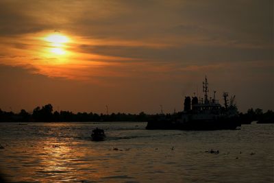 Boat in sea at sunset