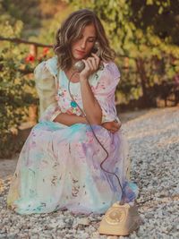 Happy woman sitting on land