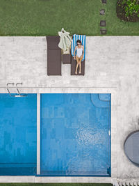 Aerial view of attractive woman near the pool at resort