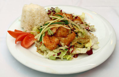 High angle view of seafood with rice in plate on table