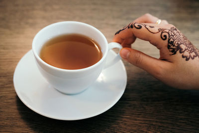 Close-up of woman holding coffee cup