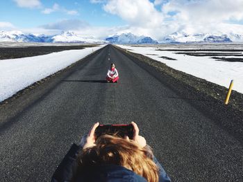 Girl sitting on road