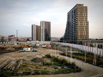 High angle view of construction site in city against sky