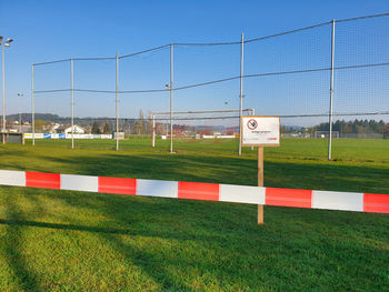 Information sign on field against clear sky