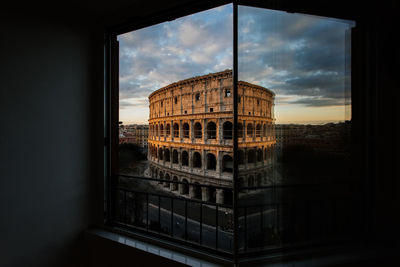 Coliseum seen through window during sunset