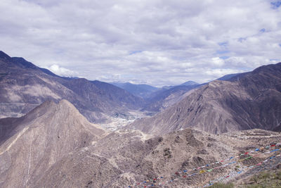 Scenic view of mountains against cloudy sky