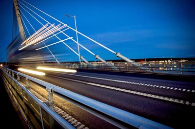 Light trails on road against sky at night