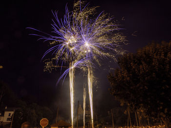 Low angle view of firework display at night