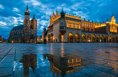 Illuminated building against sky in krakow city, poland