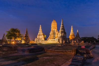 Temple by building against blue sky