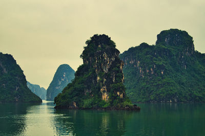 Scenic view of lake and rock formation against sky