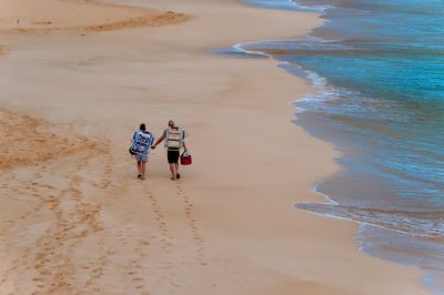 High angle view of people walking on beach