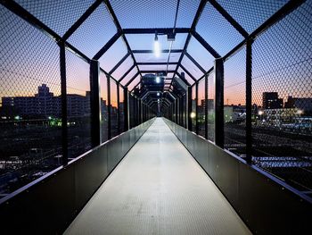 Illuminated modern building against sky during sunset