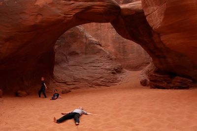 People walking on rock formation