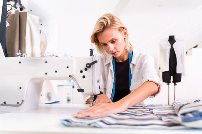 Female fashion designer working at studio