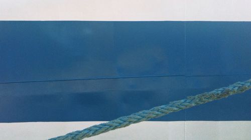 Close-up of rope against blue water