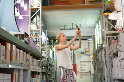 Mid adult woman standing at departmental store