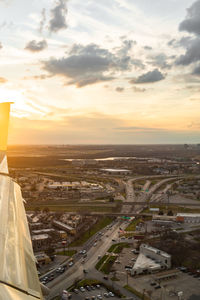 High angle view of road by buildings against sky during sunset