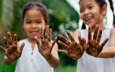 Cute friends showing dirty hands