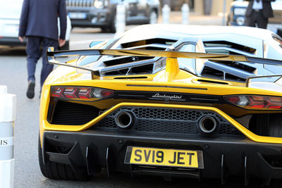 Close-up of yellow car on street