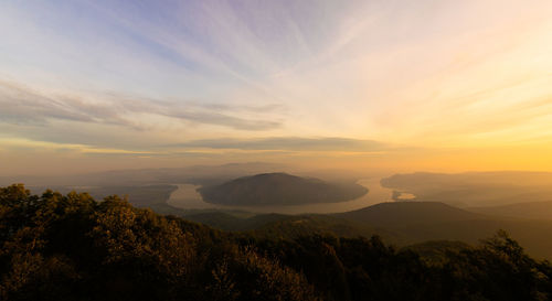 Scenic view of silhouette mountains against sky at sunset