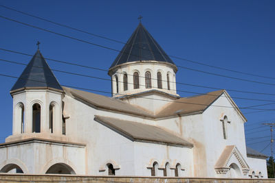 Low angle view of building against clear blue sky