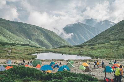 People on mountain against sky