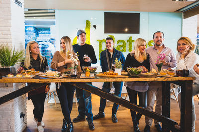 Friends standing on table