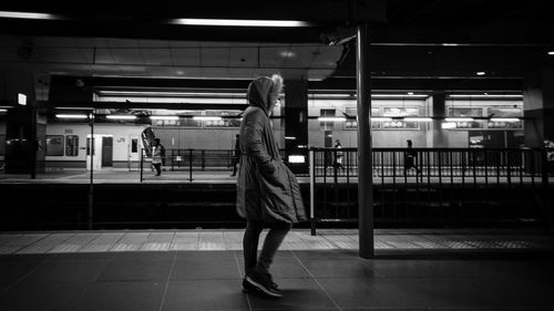 Side view of man standing on railroad station platform