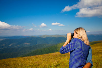 Rear view of woman against sky