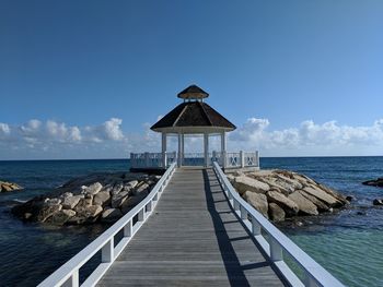 Pier over sea against sky