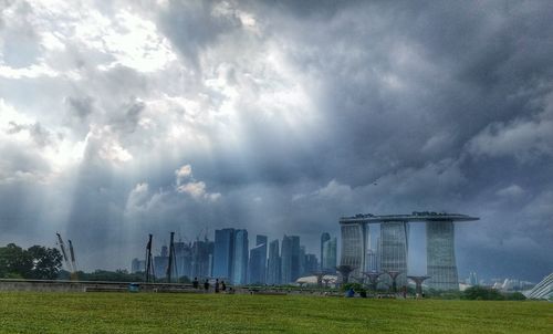 Buildings against cloudy sky