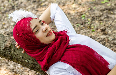 Portrait of smiling woman relaxing outdoors