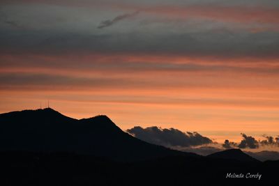 Scenic view of silhouette mountains against sky during sunset