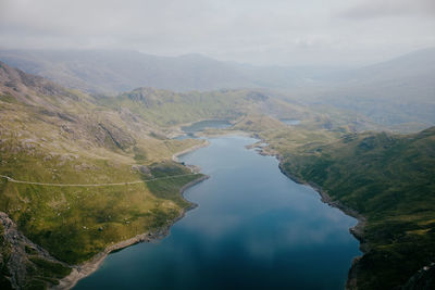 High angle view of lake amidst mountains against sky