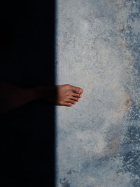 Midsection of man standing on wall