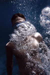 Full length of shirtless man in water