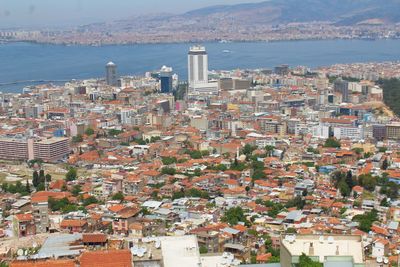 Aerial view of town by sea against sky