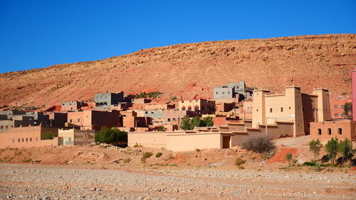 Buildings against clear blue sky