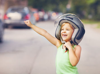 Smiling girl wearing helmet outdoors