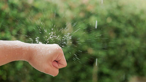 Close-up of water drops on hand