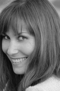 Close-up portrait of smiling woman with bangs