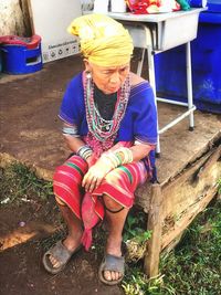 High angle view of woman sitting outdoors