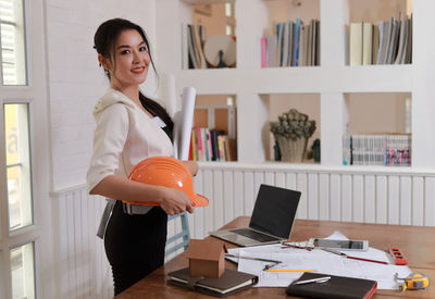 Portrait of smiling woman standing on table