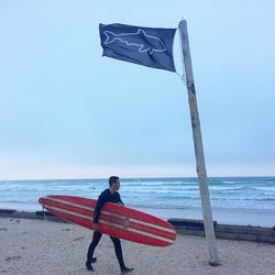 Woman on beach against sky