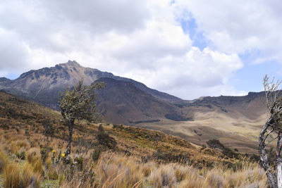 Scenic view of mountains against cloudy sky